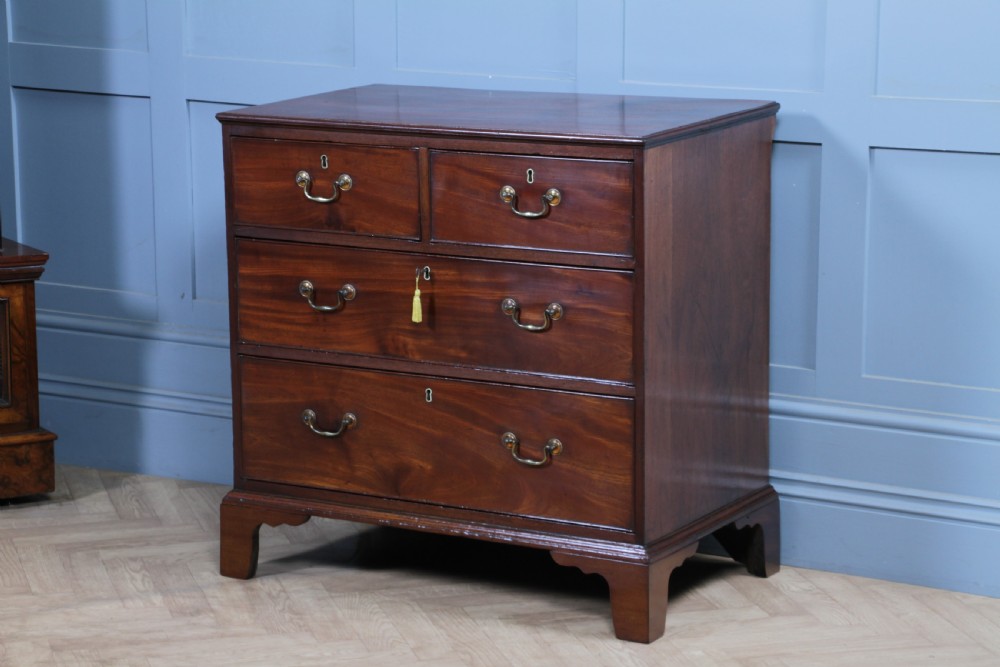 An eighteenth-century Georgian mahogany chest of drawers featuring four drawers with brass swan-neck handles and bracket feet. View XXIII