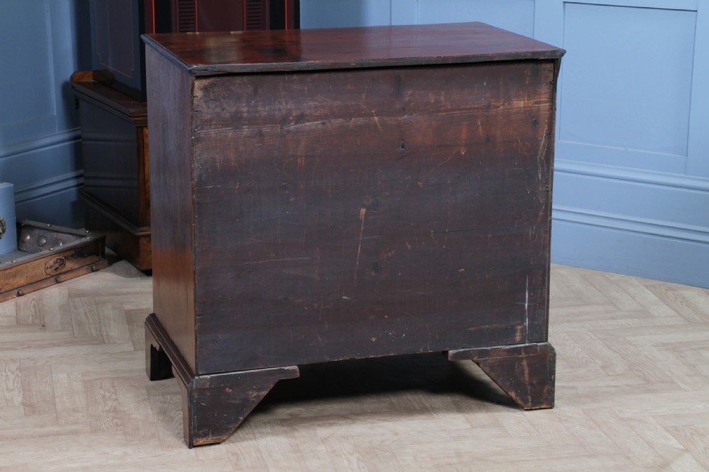 An eighteenth-century Georgian mahogany chest of drawers featuring four drawers with brass swan-neck handles and bracket feet. View XXIV