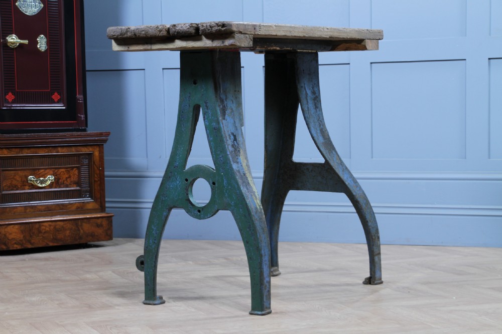 An industrial console table featuring distressed blue painted cast iron machinery legs supporting a rectangular reclaimed pine top. View III