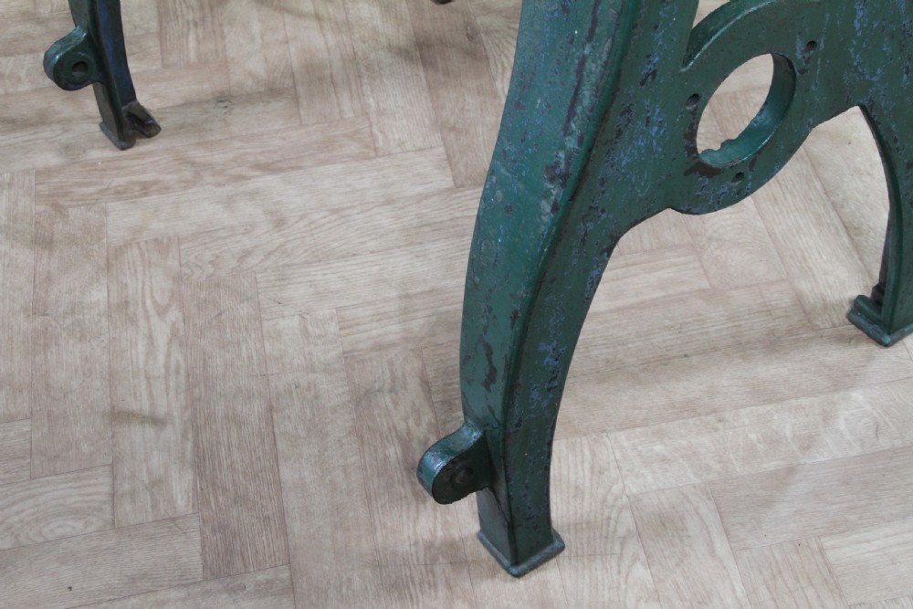 An industrial console table featuring distressed blue painted cast iron machinery legs supporting a rectangular reclaimed pine top. View XV