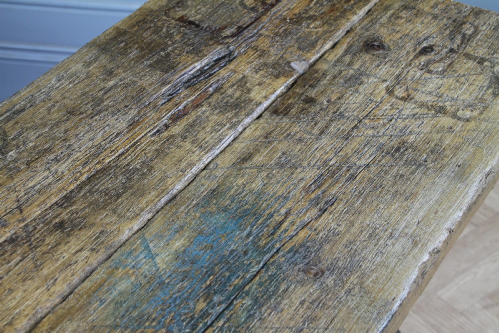 An industrial console table featuring distressed blue painted cast iron machinery legs supporting a rectangular reclaimed pine top. View XVI
