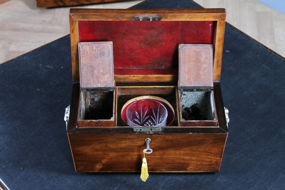 A Georgian rosewood sarcophagus-form tea caddy featuring stringing inlay, brass lion-mask side handles, and a keyhole with a tasselled key. View XIII