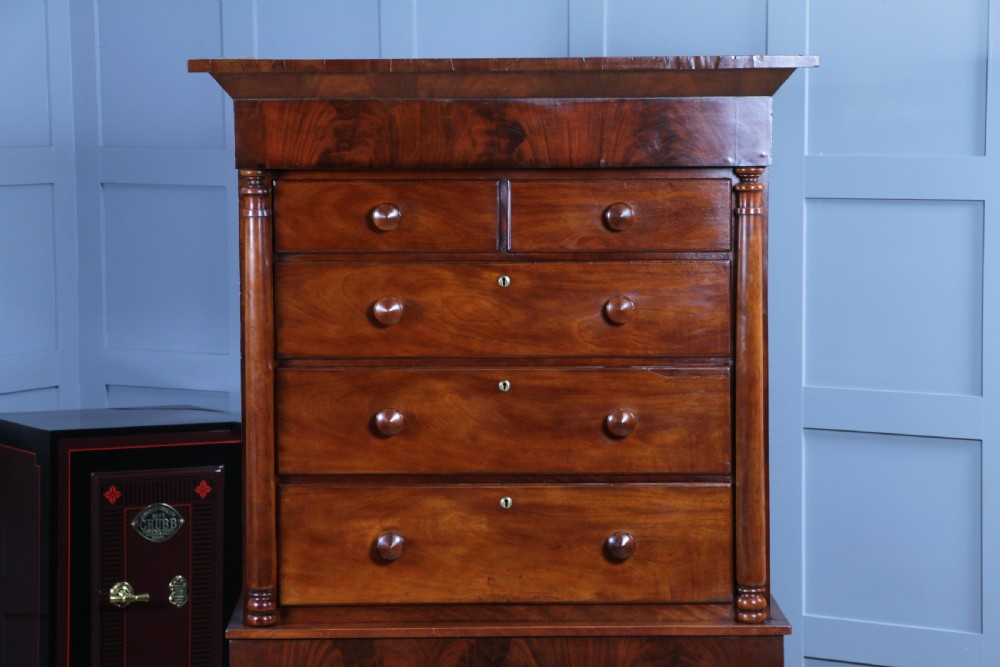 A Georgian Scottish mahogany chest on chest featuring eight drawers with turned wooden knobs, fluted side columns, and an overhanging pediment cornice. View II