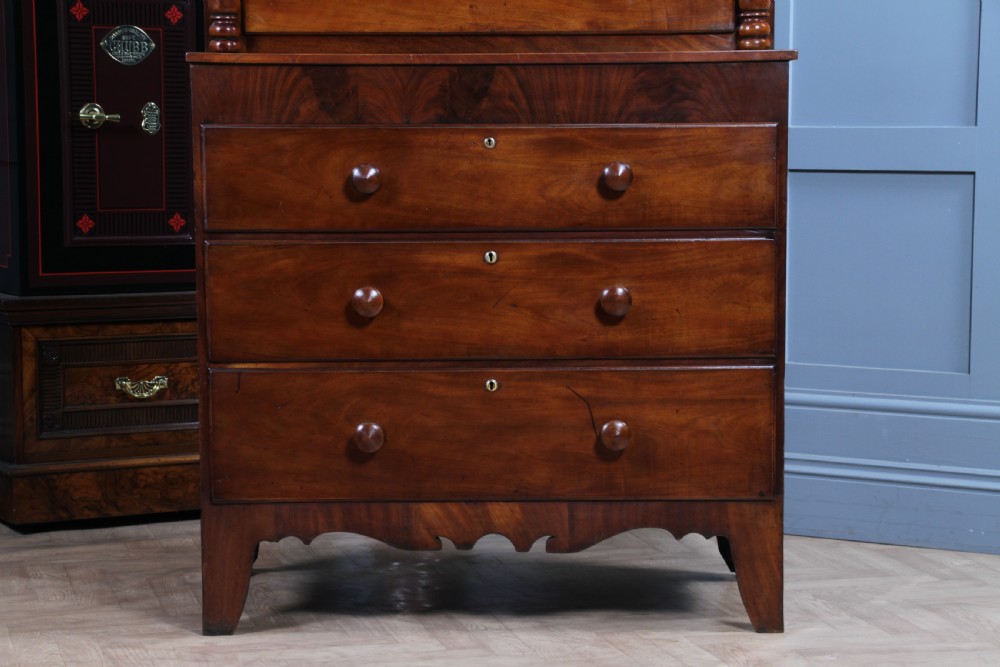A Georgian Scottish mahogany chest on chest featuring eight drawers with turned wooden knobs, fluted side columns, and an overhanging pediment cornice. View III
