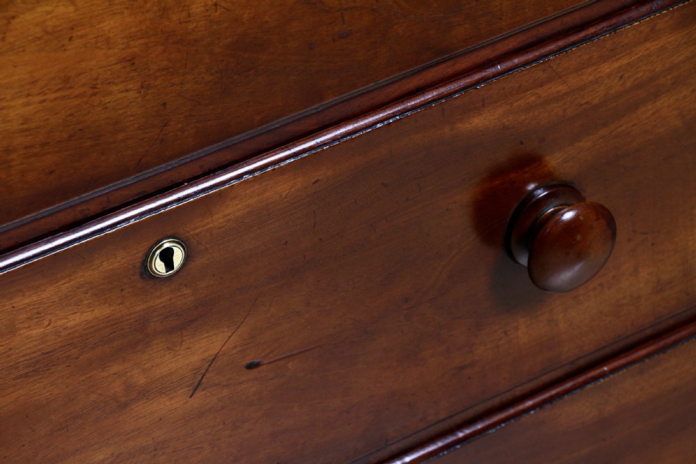 A Georgian Scottish mahogany chest on chest featuring eight drawers with turned wooden knobs, fluted side columns, and an overhanging pediment cornice. View VIII