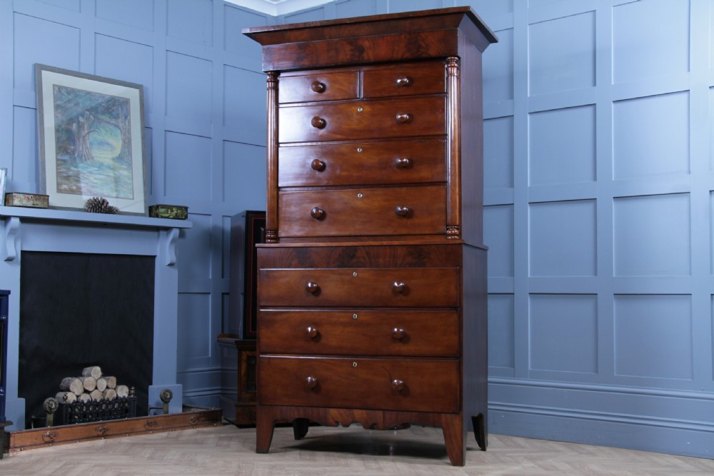 A Georgian Scottish mahogany chest on chest featuring eight drawers with turned wooden knobs, fluted side columns, and an overhanging pediment cornice. View XI