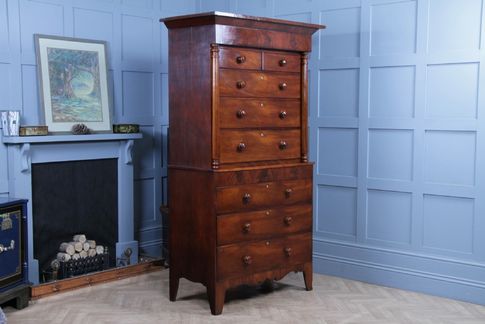 A Georgian Scottish mahogany chest on chest featuring eight drawers with turned wooden knobs, fluted side columns, and an overhanging pediment cornice. View XII