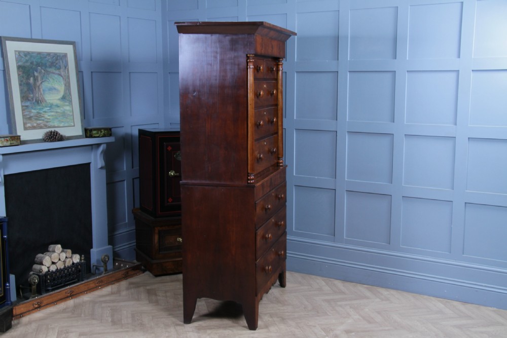A Georgian Scottish mahogany chest on chest featuring eight drawers with turned wooden knobs, fluted side columns, and an overhanging pediment cornice. View XIV