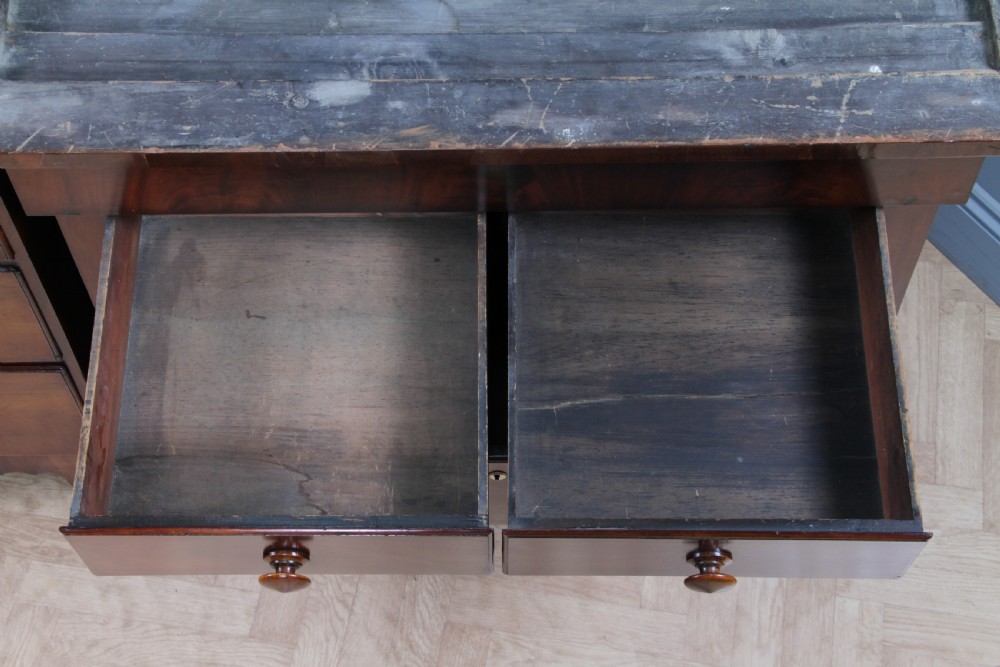 A Georgian Scottish mahogany chest on chest featuring eight drawers with turned wooden knobs, fluted side columns, and an overhanging pediment cornice. View XIX