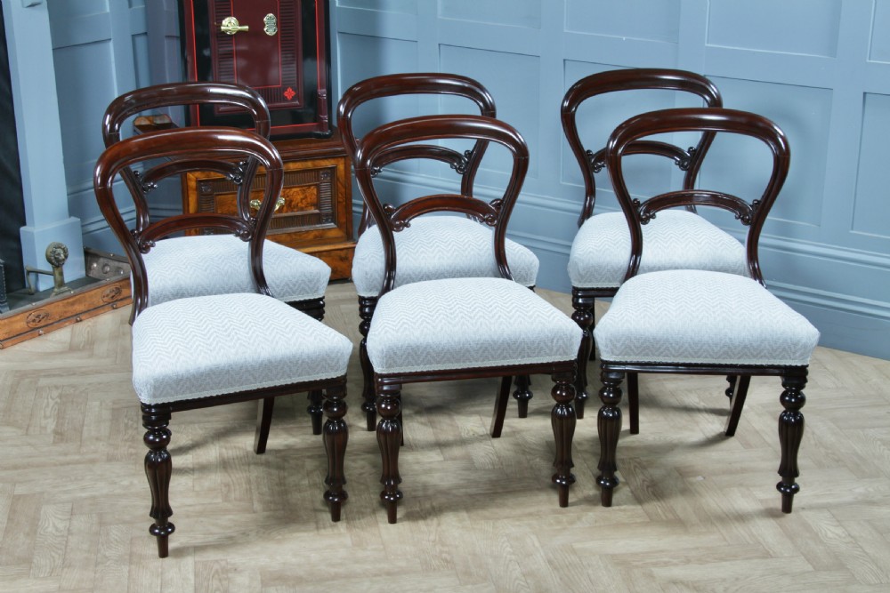 A set of six Victorian mahogany balloon back dining chairs featuring turned front legs and light grey chevron-patterned upholstered seats. View III