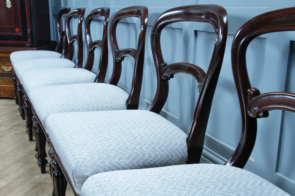 A set of six Victorian mahogany balloon back dining chairs featuring turned front legs and light grey chevron-patterned upholstered seats. View V