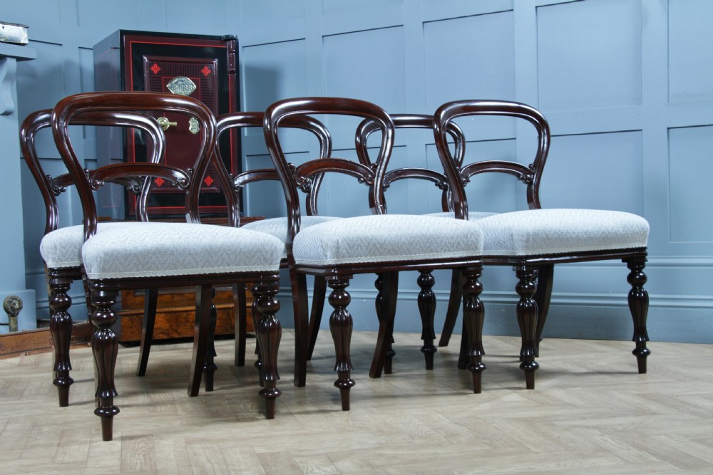 A set of six Victorian mahogany balloon back dining chairs featuring turned front legs and light grey chevron-patterned upholstered seats. View VII