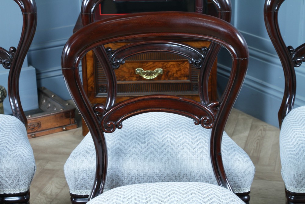 A set of six Victorian mahogany balloon back dining chairs featuring turned front legs and light grey chevron-patterned upholstered seats. View VIII