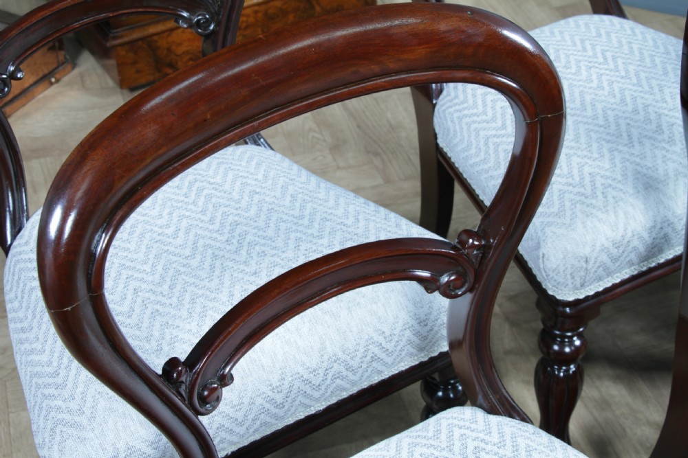 A set of six Victorian mahogany balloon back dining chairs featuring turned front legs and light grey chevron-patterned upholstered seats. View IX
