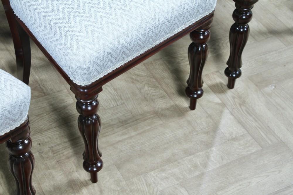 A set of six Victorian mahogany balloon back dining chairs featuring turned front legs and light grey chevron-patterned upholstered seats. View XI
