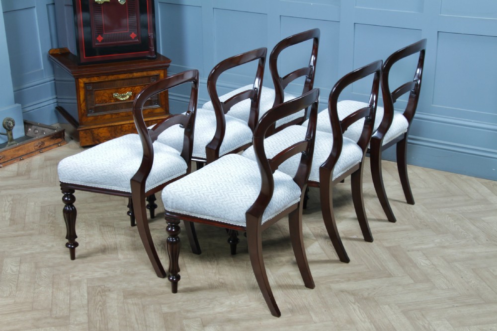 A set of six Victorian mahogany balloon back dining chairs featuring turned front legs and light grey chevron-patterned upholstered seats. View XII