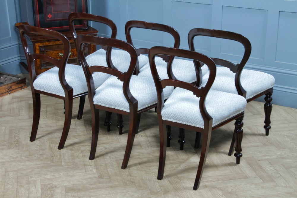 A set of six Victorian mahogany balloon back dining chairs featuring turned front legs and light grey chevron-patterned upholstered seats. View XIII
