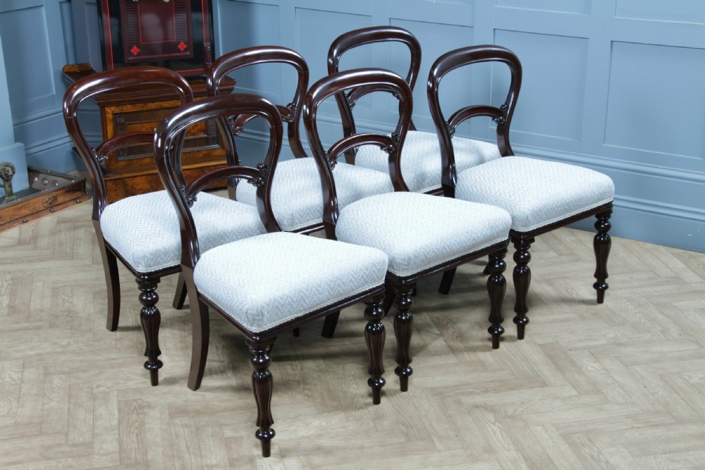 A set of six Victorian mahogany balloon back dining chairs featuring turned front legs and light grey chevron-patterned upholstered seats. View XIV