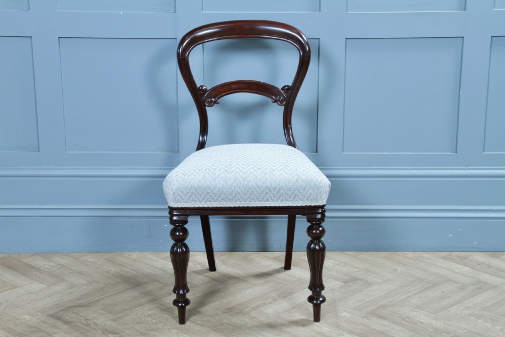 A set of six Victorian mahogany balloon back dining chairs featuring turned front legs and light grey chevron-patterned upholstered seats. View XVI
