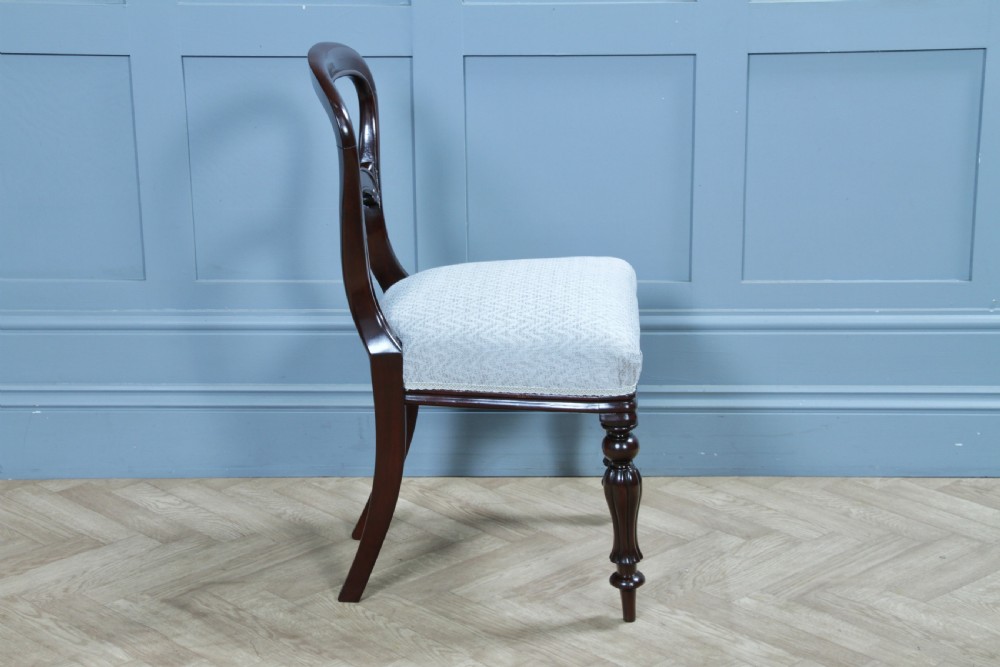 A set of six Victorian mahogany balloon back dining chairs featuring turned front legs and light grey chevron-patterned upholstered seats. View XVII