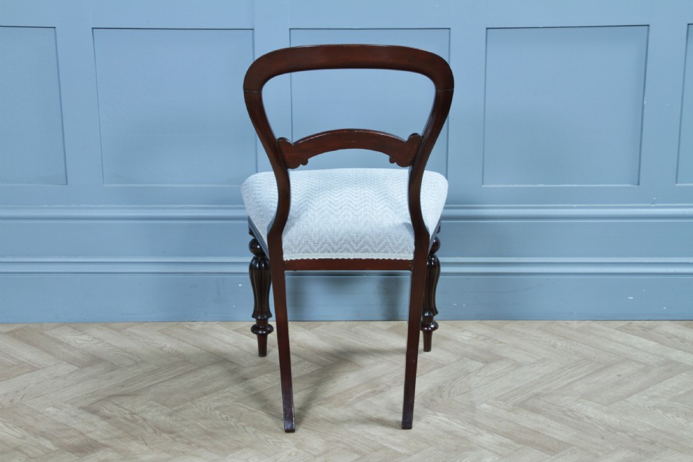 A set of six Victorian mahogany balloon back dining chairs featuring turned front legs and light grey chevron-patterned upholstered seats. View XVIII