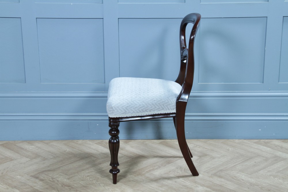 A set of six Victorian mahogany balloon back dining chairs featuring turned front legs and light grey chevron-patterned upholstered seats. View XIX
