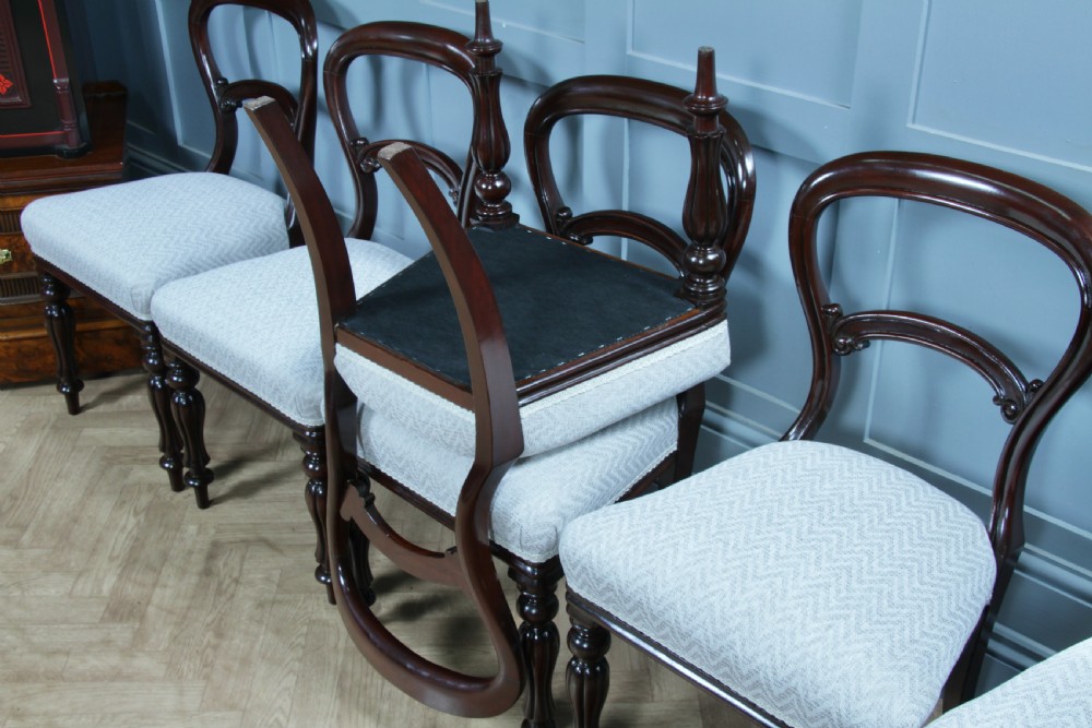 A set of six Victorian mahogany balloon back dining chairs featuring turned front legs and light grey chevron-patterned upholstered seats. View XXI
