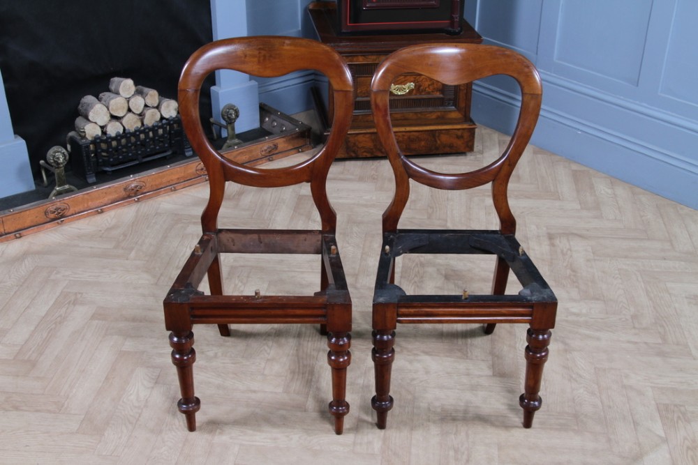 A set of eight Victorian mahogany dining chairs featuring open rounded balloon backs, turned front legs, and neutral patterned upholstered seats. View XIII