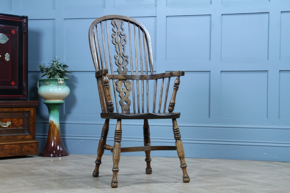 A traditional high-back Windsor armchair crafted from ash and elm wood, featuring a pierced central splat, spindled backrest, turned legs, and a cow horn stretcher. View II