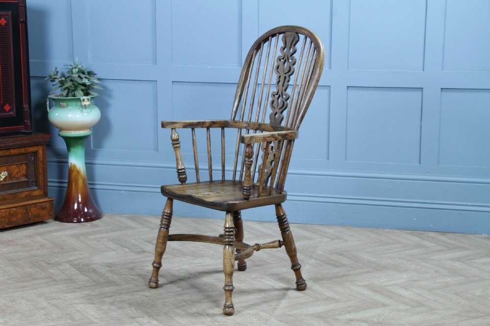 A traditional high-back Windsor armchair crafted from ash and elm wood, featuring a pierced central splat, spindled backrest, turned legs, and a cow horn stretcher. View III