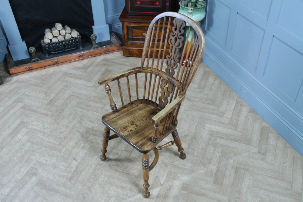 A traditional high-back Windsor armchair crafted from ash and elm wood, featuring a pierced central splat, spindled backrest, turned legs, and a cow horn stretcher. View IV