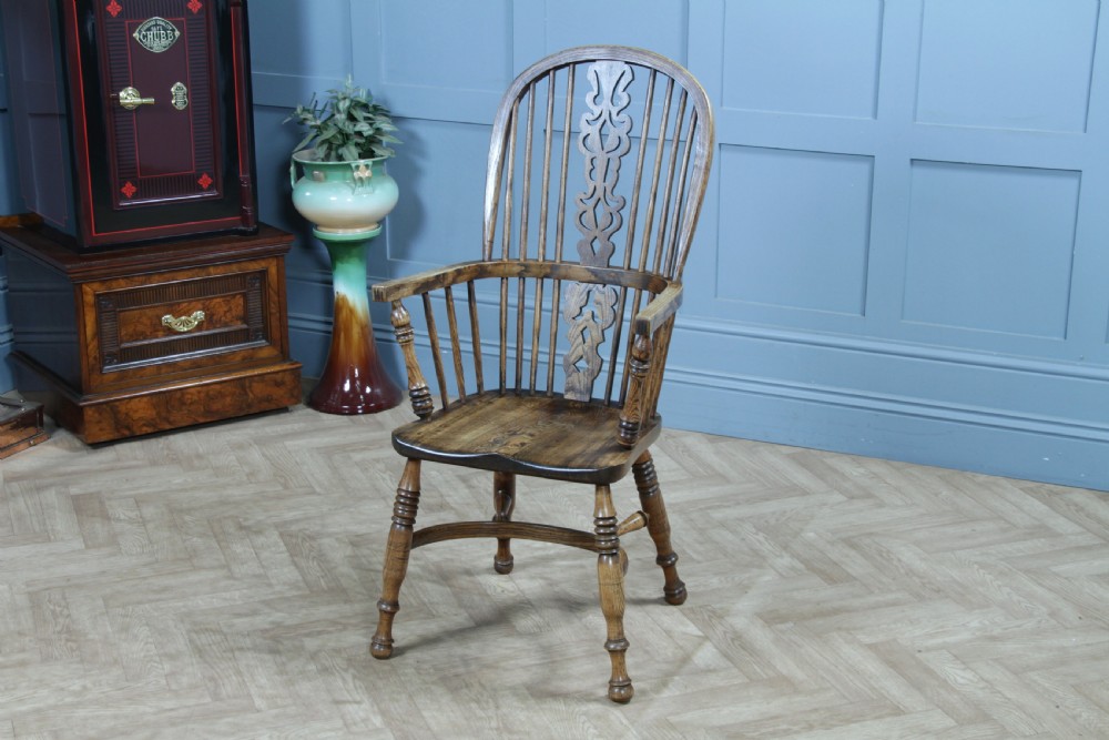 A traditional high-back Windsor armchair crafted from ash and elm wood, featuring a pierced central splat, spindled backrest, turned legs, and a cow horn stretcher. View VII