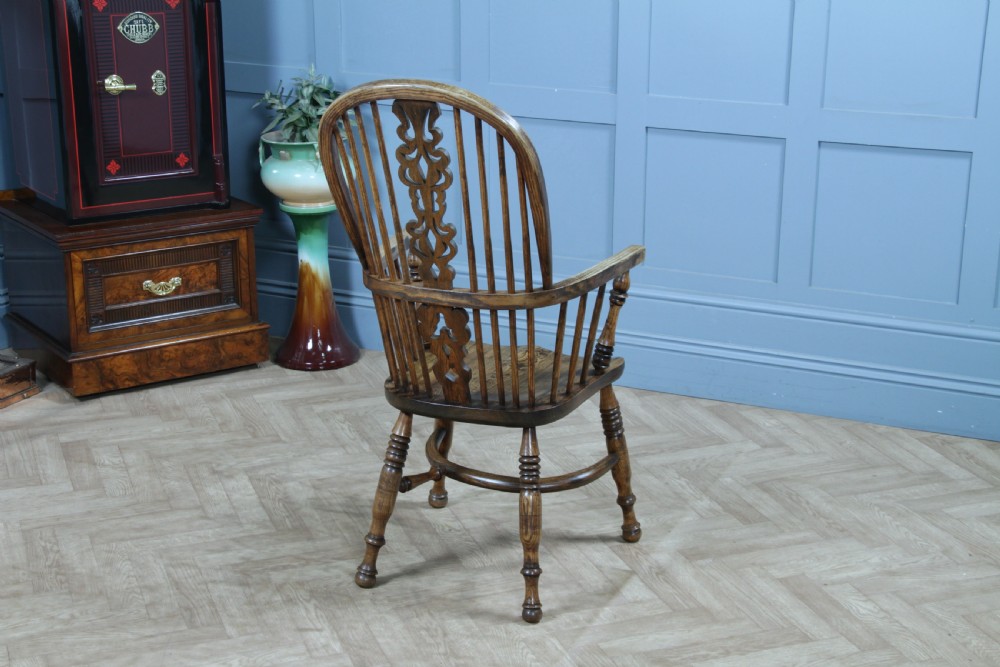 A traditional high-back Windsor armchair crafted from ash and elm wood, featuring a pierced central splat, spindled backrest, turned legs, and a cow horn stretcher. View IX