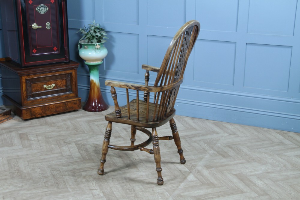A traditional high-back Windsor armchair crafted from ash and elm wood, featuring a pierced central splat, spindled backrest, turned legs, and a cow horn stretcher. View X