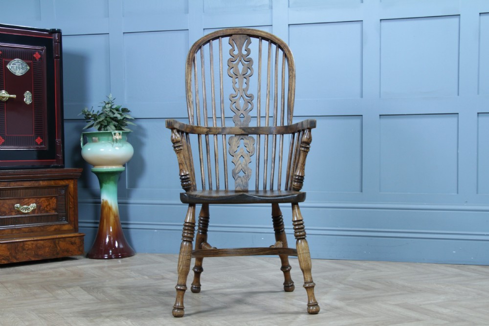 A traditional high-back Windsor armchair crafted from ash and elm wood, featuring a pierced central splat, spindled backrest, turned legs, and a cow horn stretcher. View XI