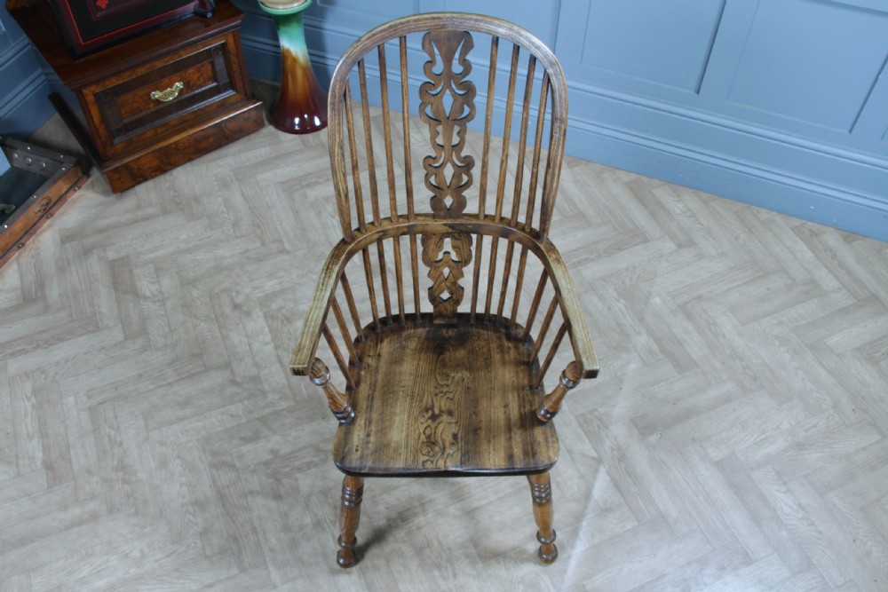 A traditional high-back Windsor armchair crafted from ash and elm wood, featuring a pierced central splat, spindled backrest, turned legs, and a cow horn stretcher. View XII