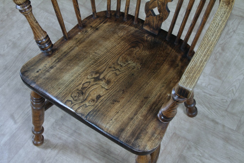 A traditional high-back Windsor armchair crafted from ash and elm wood, featuring a pierced central splat, spindled backrest, turned legs, and a cow horn stretcher. View XVII