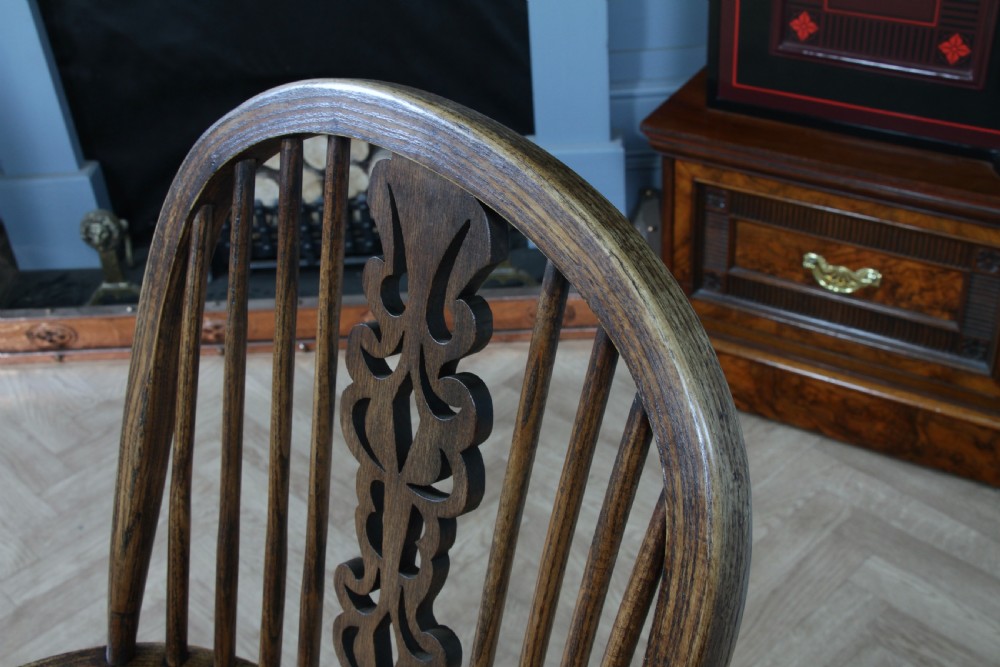 A traditional high-back Windsor armchair crafted from ash and elm wood, featuring a pierced central splat, spindled backrest, turned legs, and a cow horn stretcher. View XVIII