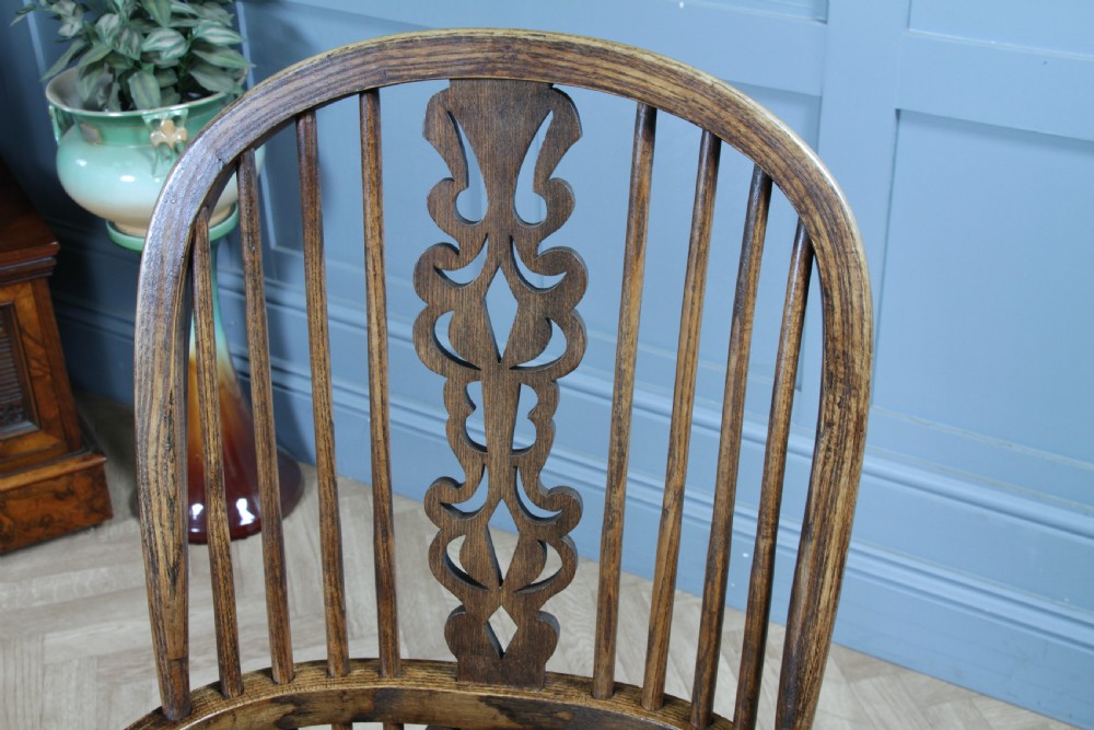 A traditional high-back Windsor armchair crafted from ash and elm wood, featuring a pierced central splat, spindled backrest, turned legs, and a cow horn stretcher. View XIX
