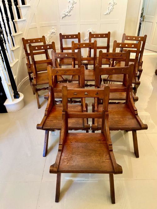 Unusual Antique Set of Twelve Gothic Pitch Pine Dining Chairs
