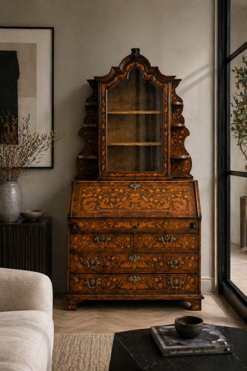 fig 1. An antique Dutch walnut bureau bookcase featuring floral marquetry inlay, a fall-front writing slope, drawers, and an arched glazed display cabinet with tiered side shelves.