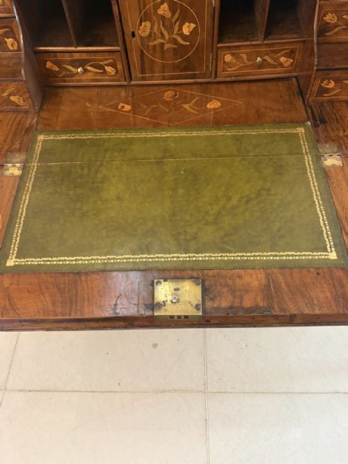 fig 3. An antique Dutch walnut bureau bookcase featuring floral marquetry inlay, a fall-front writing slope, drawers, and an arched glazed display cabinet with tiered side shelves.