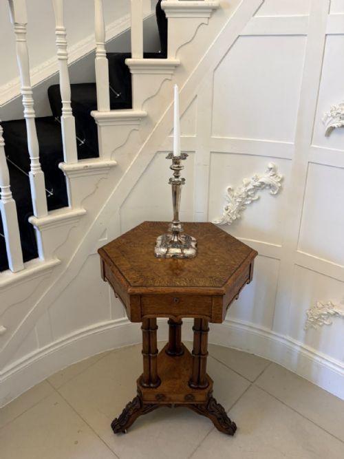 fig 2. An antique hexagonal pollard oak side table featuring a lift-top lid, ring-turned column supports, and a carved tripartite base with castors.
