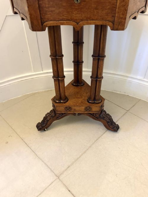 fig 8. An antique hexagonal pollard oak side table featuring a lift-top lid, ring-turned column supports, and a carved tripartite base with castors.
