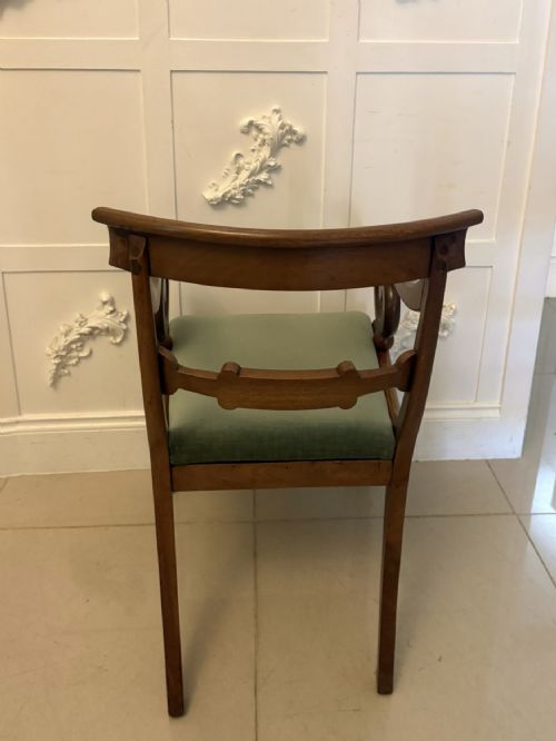 fig 2. A set of eight antique Regency mahogany dining chairs featuring green velvet upholstery, turned front legs, and two scroll arm carvers.