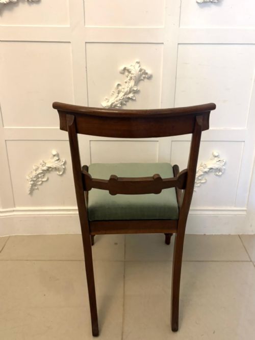 fig 4. A set of eight antique Regency mahogany dining chairs featuring green velvet upholstery, turned front legs, and two scroll arm carvers.