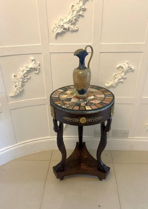 fig 2. A circular antique side table with a specimen marble top, mahogany apron with brass mounts, and carved swan supports on a triform base.