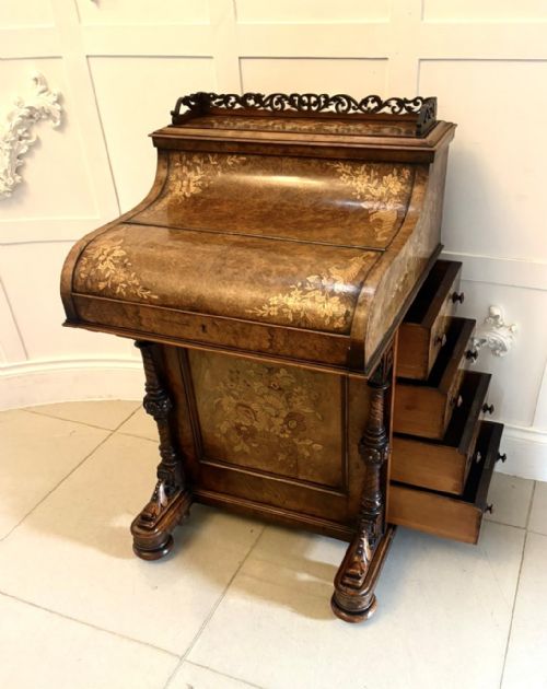 fig 3. An antique Victorian burr walnut piano top Davenport desk featuring intricate floral marquetry, side drawers, and carved supports.