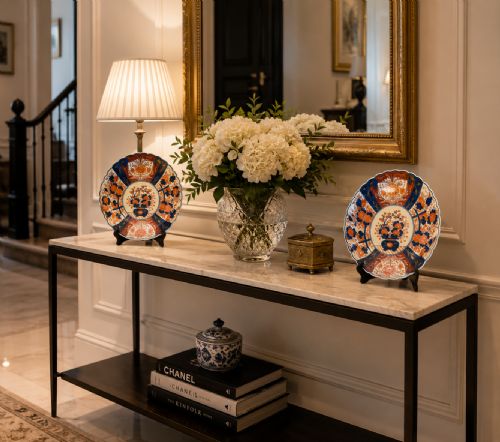 fig 1. A pair of antique Japanese Imari porcelain plates featuring scalloped edges, cobalt blue and orange floral panels, and a central floral motif.