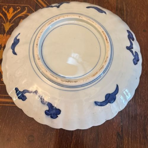 fig 2. A pair of antique Japanese Imari porcelain plates featuring scalloped edges, cobalt blue and orange floral panels, and a central floral motif.